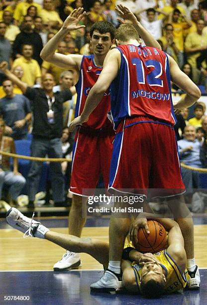 Anthony Parker of Maccabi Tel Aviv catches a rebound between the legs of CSKA Moscow players Sergey Monya and Anton Yudin during their semi-final...