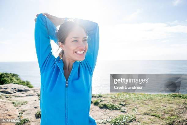 happy woman stretching - muscle men at beach stockfoto's en -beelden