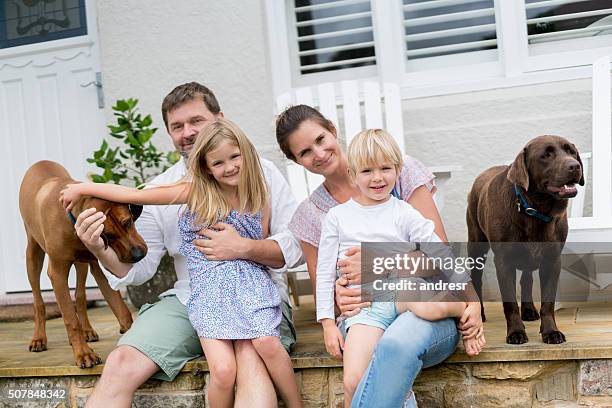 happy family at home with their dogs - australian family home stock pictures, royalty-free photos & images