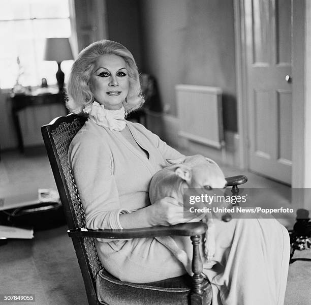 English model and trans pioneer, April Ashley posed holding a dog in London on 21st April 1982.