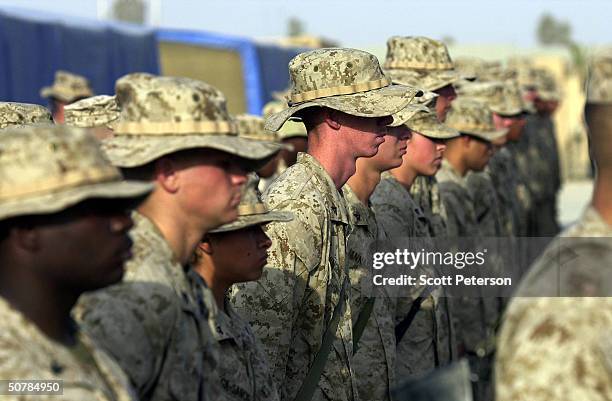 Marines line up on April 29, 2004 in Fallujah, Iraq. While U.S. Marine commanders hold peace talks, marines ready for battle at their base east of...