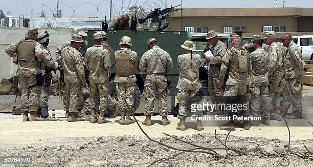 Marines gather to talk on April 29, 2004 in Fallujah, Iraq. While U.S. Marine commanders hold peace talks, marines ready for battle at their base...