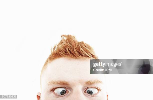 cropped studio shot of young man crossing eyes - louche photos et images de collection