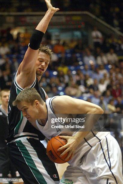Finnish basketball star Hanno Mottola of Skipper Bologna drives against Danish national player David Andersen of Montepaschi Siena during the two...