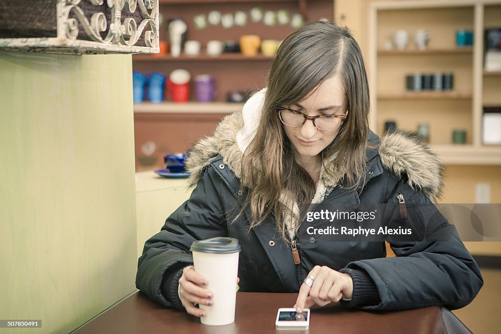 Mid Adult Woman Texting On Smartphone In Cafe High-Res Stock Photo ...