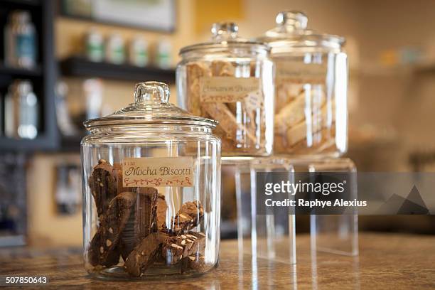 close up of jars of biscotti on cafe counter - pot met koekjes stockfoto's en -beelden