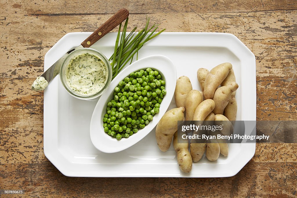 Fingerling potatoes and spring peas served with a chive compound butter