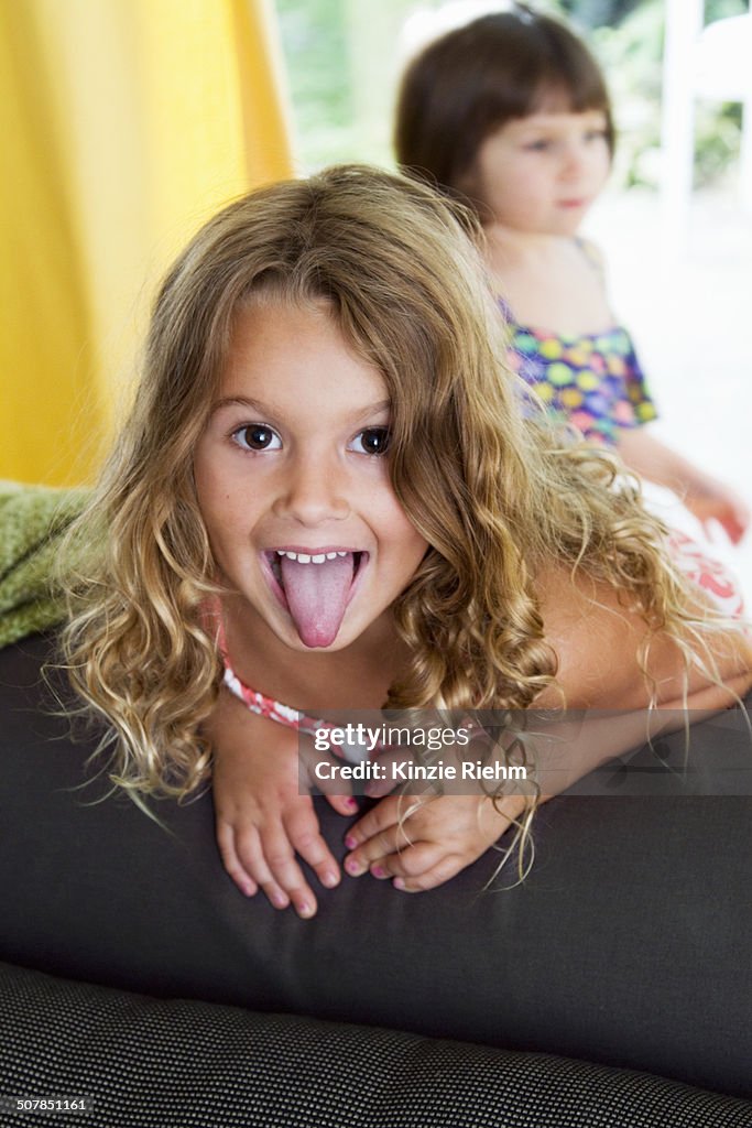 Portrait of confident girl sticking her tongue out