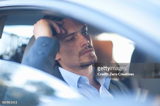 mid adult businessman driving in traffic congestion - busy street imagens e fotografias de stock