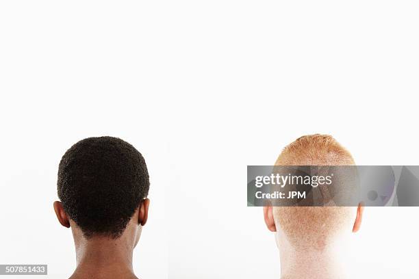 rear view studio portrait of young couple's cropped hair - back of head stockfoto's en -beelden