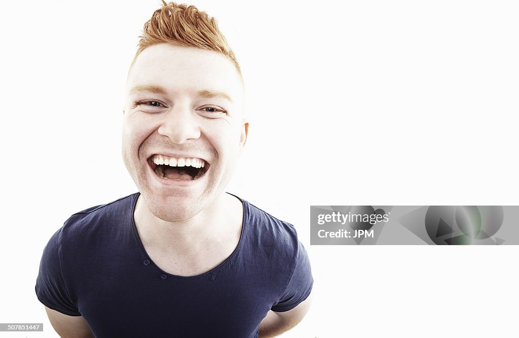 Studio portrait of young man laughing