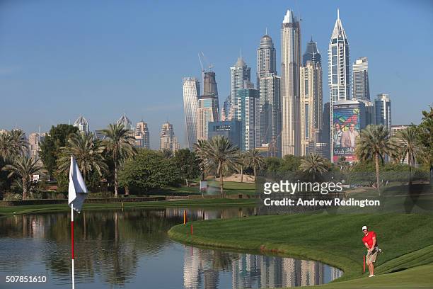 Rory McIlroy of Northern Ireland plays a chip shot on the fourth hole during practice for the 2016 Omega Dubai Desert Classic on the Majlis Course at...