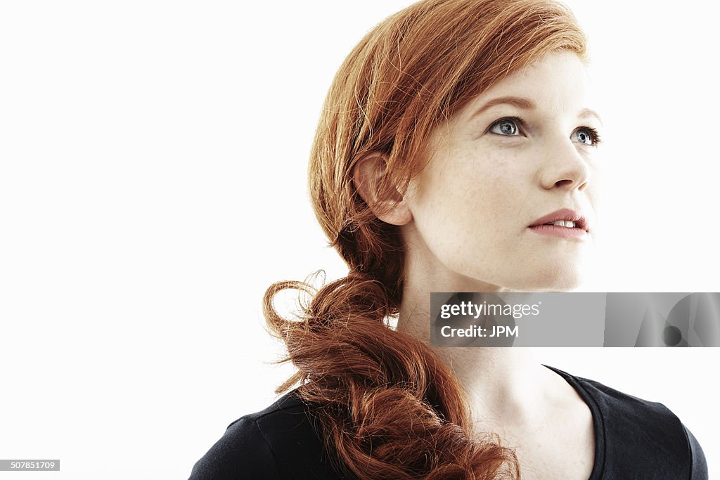 Studio portrait of young woman gazing upwards