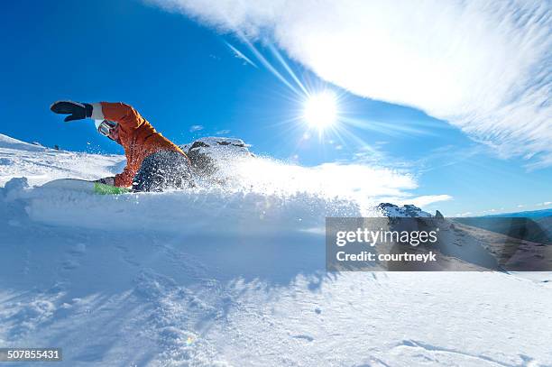 snowboarder turning on a blue sky day - ski new zealand stock pictures, royalty-free photos & images