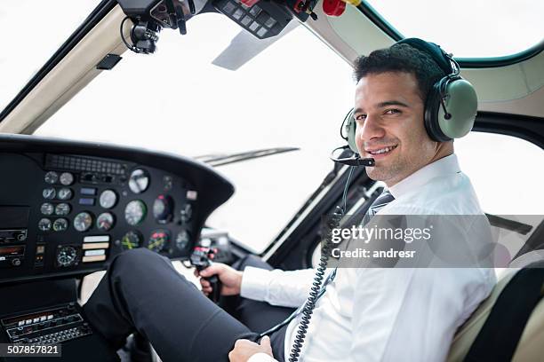 pilot flying a helicopter - helicopter pilot stock pictures, royalty-free photos & images