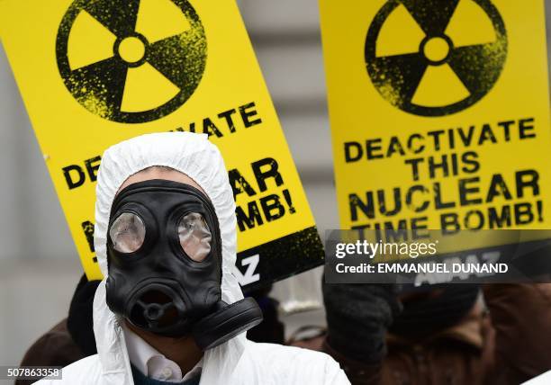 An anti-nuclear activist wearing gas mask is pictured during a protest against the lack of safety of Belgian nuclear power plants, outside the...