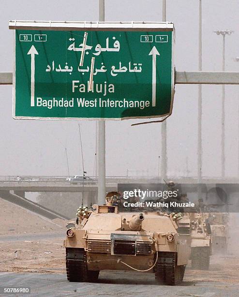 Tanks roll away from their positions on the outskirts of the flashpoint Iraqi city of Fallujah April 30, 2004 in Iraq. U.S. Forces began a limited...