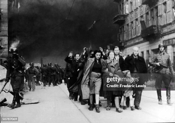 Captured Jewish civilians who participated in the Warsaw Ghetto Uprising are marched out of the city by Nazi troops, Warsaw, Poland, April 19, 1943.