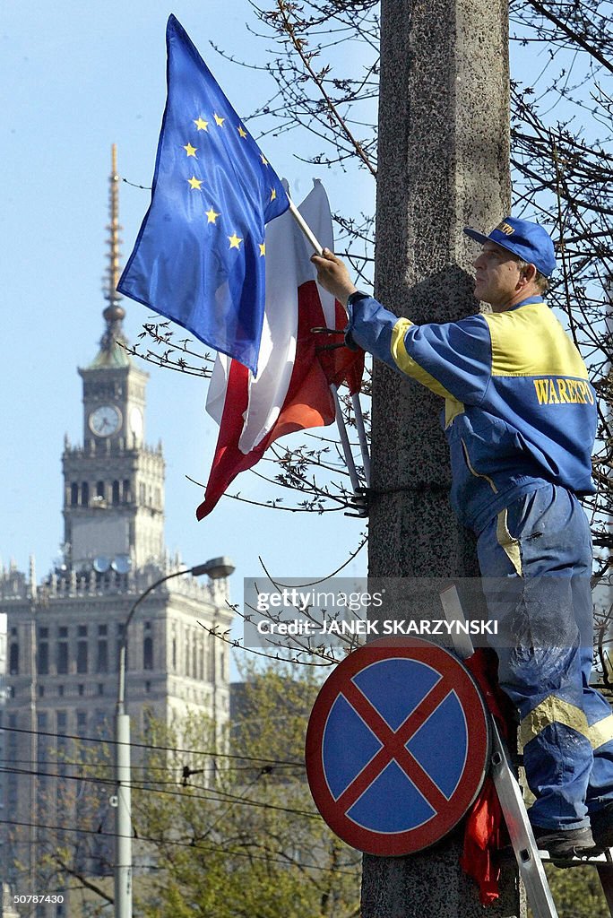 A worker installs Polish national and EU