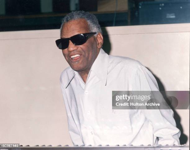 American singer, pianist and songwriter Ray Charles arrives at an unidentified event, circa 1995.