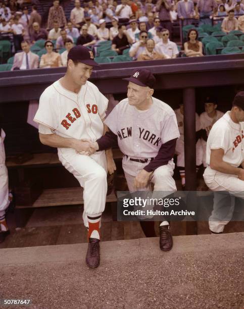 American baseball player Ted Williams of the Boston Red Sox shakes hands with Casey Stengel , the manager of the New York Yankees, circa 1950s.
