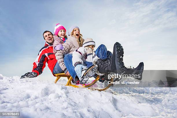 family sledging. - sledding stock pictures, royalty-free photos & images