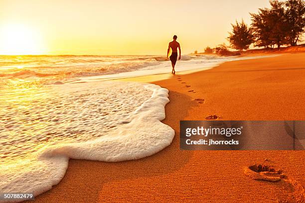 sunset surfer - hunky guy on beach stock pictures, royalty-free photos & images