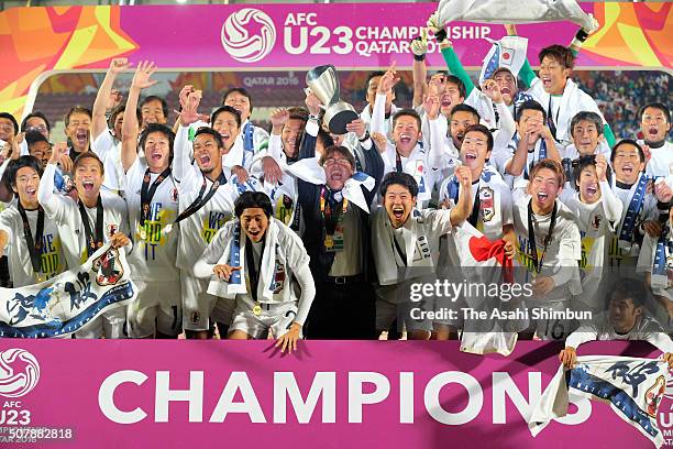 Makoto Teguramori Head coach of Japan lifts the trophy after winning the AFC U-23 Championship final match between South Korea and Japan at the...