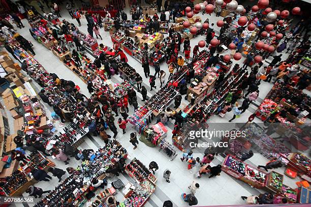 People purchase items in preparation for the upcoming Spring Festival at a shopping mall on January 31, 2016 in Hangzhou, China. Chinese people are...