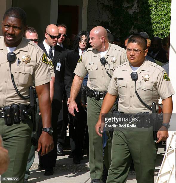 Pop Star Michael Jackson, surrounded by private security and police, departs the Santa Maria courthouse April 30, 2004 in Santa Maria, California....