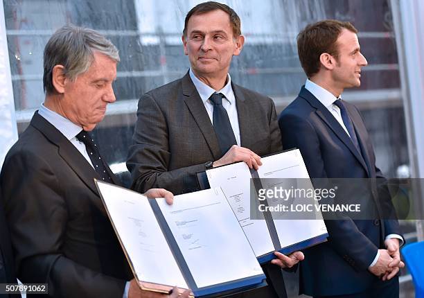 Mediterranean Shipping Company owner Gianluigi Aponte and STX shipyards general director Laurent Castaing present their contracts next to French...