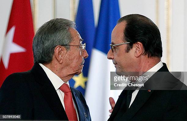 Cuban President Raul Castro talks with French President Francois Hollande after their meeting at the Elysee Presidential Palace on February 01, 2016...