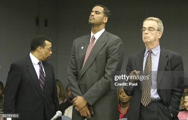 Former NBA player Jayson Williams, stands with defense attorneys Billy Martin and Joseph Hayden as the jury foreman reads the verdicts in Williams'...