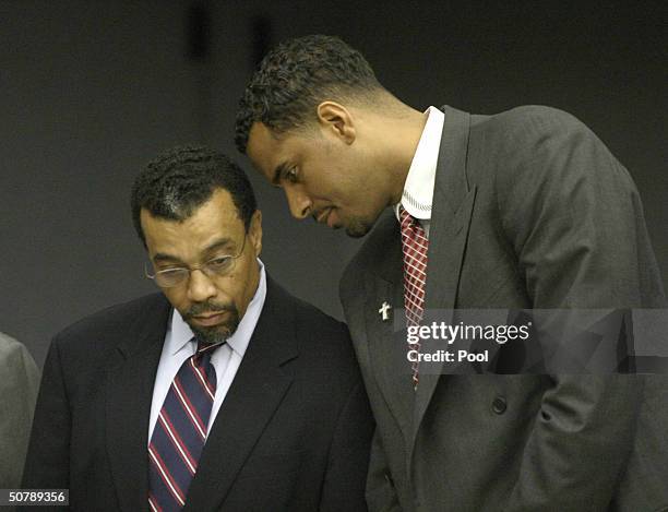 Former NBA player Jayson Williams talks with defense attorney Billy Martin as the jury foreman reads the verdicts in Williams' manslaughter trial at...