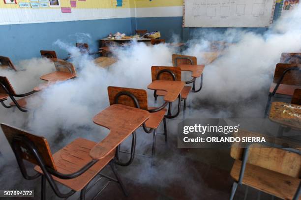 Health ministry personnel fumigate a classroom against the Aedes aegypti mosquito, vector of the dengue, Chikungunya and Zika viruses in Tegucigalpa,...