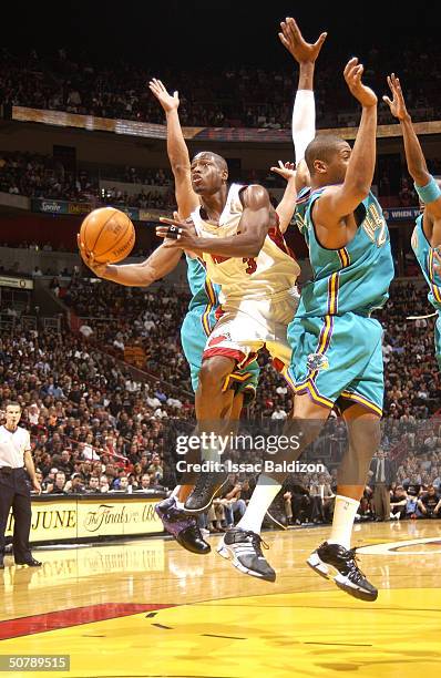 Dwyane Wade of the Miami Heat takes a shot against Jamaal Magloire of the New Orleans Hornets in Game five of the Eastern Conference Quarterfinals...