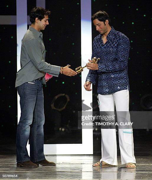 Male Model of the Year Zulfi Syaad is awarded his trophy by presenter Urmila Matonker during the 2004 Bollywood Fashion Awards at the Trump Taj...