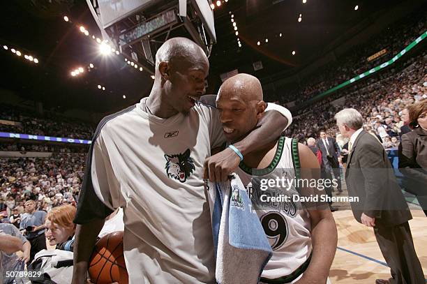 Kevin Garnett of the Minnesota Timberwolves celebrates with teammate Sam Cassell after winning the game against the Denver Nuggets after Game five of...