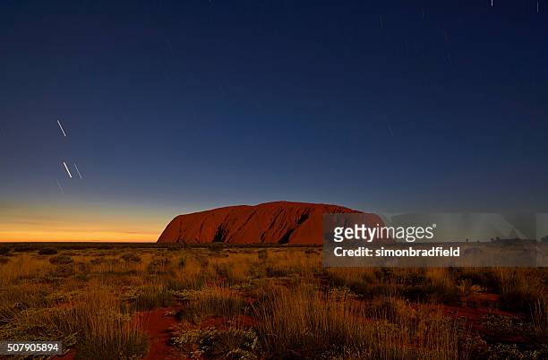 uluru in the moonlight - uluru rock stock pictures, royalty-free photos & images