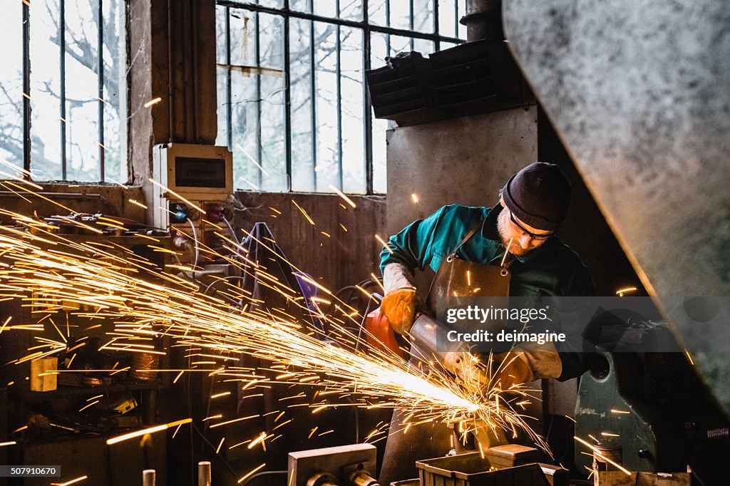 Craftsman repairman working with grinder