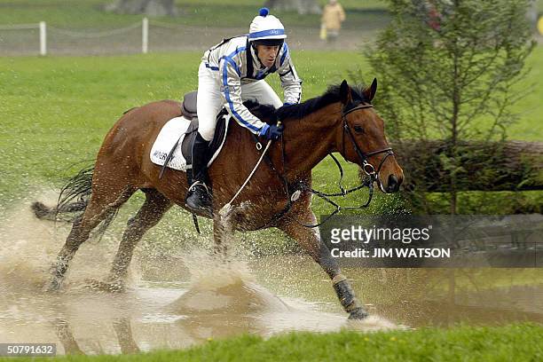 Australian Andrew Hoy runs through the water at jump 12 on Mr. Pracatan 01 May 2004 during the cross country section of the Mistubishi Motors...