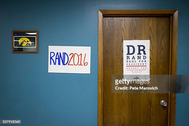 Signs adorn the wall of the Rand Paul Des Moines campaign headquarters on February 1, 2016 in Des Moines, Iowa. Paul volunteers worked the phones in...