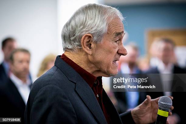 Former Congressman Ron Paul introduces his son, Senator Rand Paul during a caucus day rally at the Des Moines campaign headquarters on February 1,...