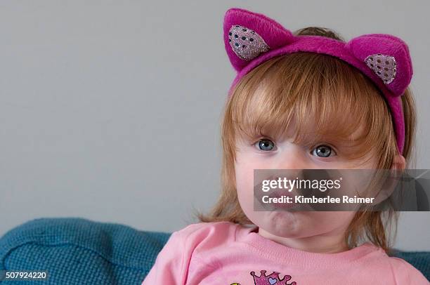 girl making silly face - cat ears headband stock pictures, royalty-free photos & images