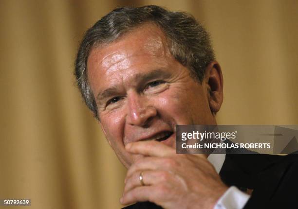 President George W. Bush laughs at jokes made by comedian Jay Leno at the White House Correspondents' Association dinner in Washington, DC, 01 May...