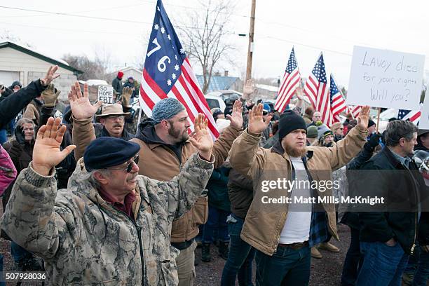 Anti-government protesters raise their arms in the air and shout 'hands up don't shoot' outside the Harney County Courthouse on February 1, 2016 in...
