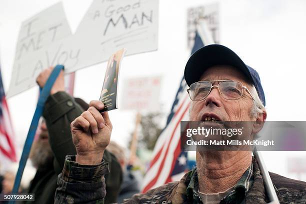 Man protesting the FBI's presence at the Malheur National Wildlife Refuge holds up a constitution during a protest at the Harney County Courthouse on...