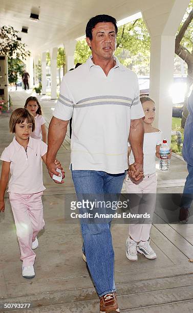 Actor Sylvester Stallone and his daughters attend the 14th Annual Hollywood Charity Horse Show on May 1, 2004 at the Los Angeles Equestrian Center in...