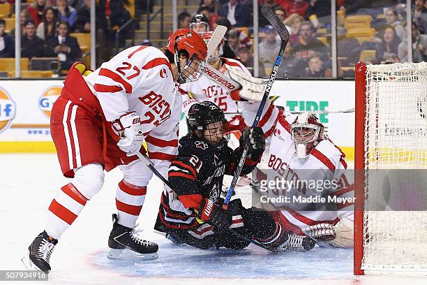 Nolan Stevens of the Northeastern Huskies collides with Sean Maguire of the Boston University Terriers in the goal during the second period at TD...