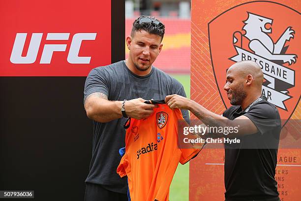 Fighter Frank Mir and Brisbane Roar player Henrique swap shirts during a media opportunity at Suncorp Stadium on February 2, 2016 in Brisbane,...